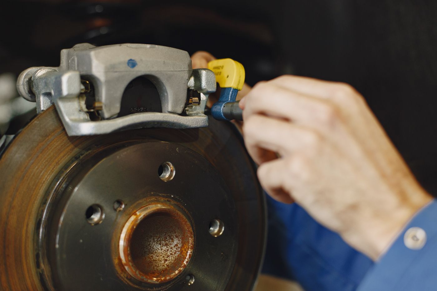 Close-up of a disc brake during service; illustrative service photography